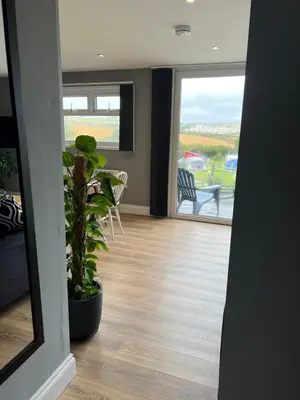 a hallway with a view of a living room at The Lodge in Perranporth