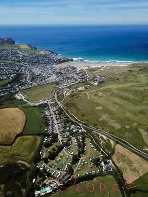 an aerial view of a city with the ocean at The Lodge in Perranporth
