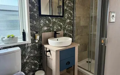 a bathroom with a sink and a shower at Vyvyenne Lodge in Padstow