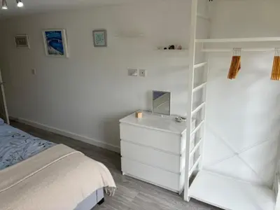 a bedroom with a white bunk bed and a white dresser at Park Rd in Redruth