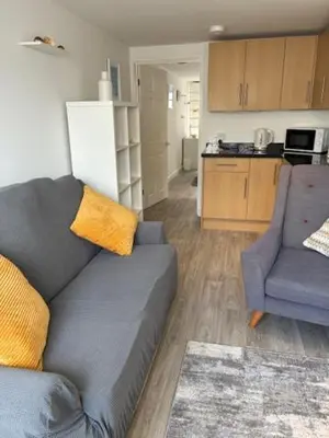 a living room with a couch and a kitchen at Park Rd in Redruth