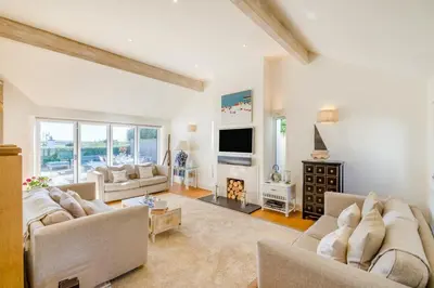 a living room with white furniture and a fireplace at 5 Bed in Rock oc-m33185 in Roche