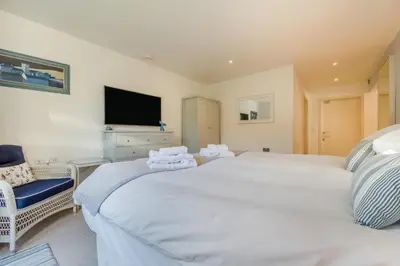 a bedroom with two large white beds and a tv at 5 Bed in Rock oc-m33185 in Roche