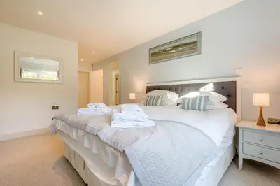 a bedroom with a large white bed with towels on it at 5 Bed in Rock oc-m33185 in Roche