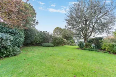 a yard with a large lawn with trees and bushes at 1 Bed in Fowey oc-p33360 in Fowey