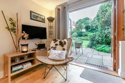 a living room with a chair and a television at 1 Bed in Fowey oc-p33360 in Fowey