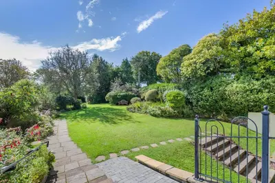 a garden with a gate and a grass yard at 3 Bed in Fowey oc-o33078 in Fowey