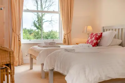 a bedroom with two beds and a window at 3 Bed in Fowey oc-o33078 in Fowey