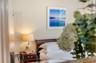 a bedroom with a bed and a table with a lamp at 3 Bed in Fowey oc-o33078 in Fowey