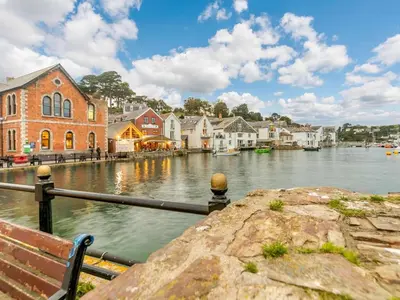 a view of a river with houses and a bench at 3 Bed in Fowey oc-o33078 in Fowey