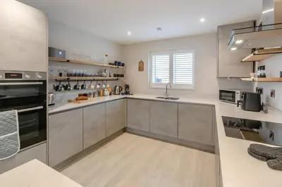 a large kitchen with stainless steel appliances and a window at 3 Bed in Fowey oc-s33234 in Fowey