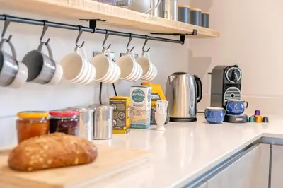 a kitchen counter with a loaf of bread on a cutting board at 3 Bed in Fowey oc-s33234 in Fowey