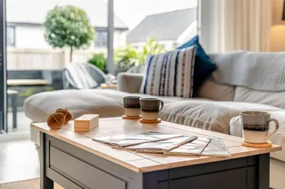 a coffee table in a living room with two cups on it at 3 Bed in Fowey oc-s33234 in Fowey