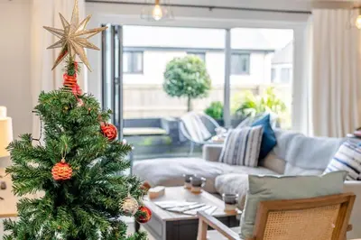 a christmas tree in a living room with a couch at 3 Bed in Fowey oc-s33234 in Fowey