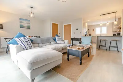a living room with a white couch and a table at 3 Bed in Fowey oc-s33234 in Fowey