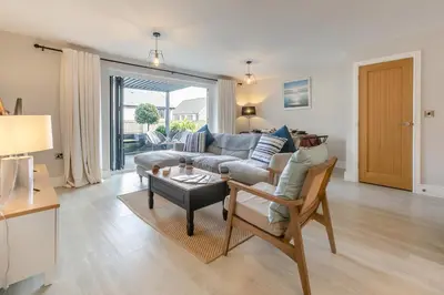 a living room with a couch and a table at 3 Bed in Fowey oc-s33234 in Fowey