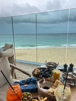 a table with food and a view of the beach at The Mowhay tranquil farm stay with views in Redruth