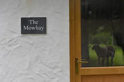 a door with a sign that reads the mowshaw at The Mowhay tranquil farm stay with views in Redruth