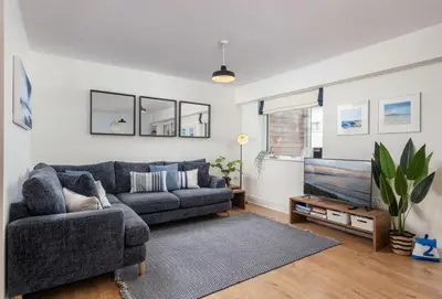 a living room with a couch and a tv at 12 Ocean One in Newquay