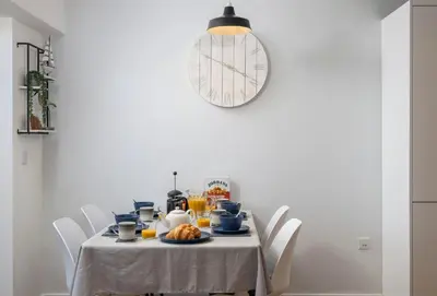 a dining room table with a white table cloth at 12 Ocean One in Newquay