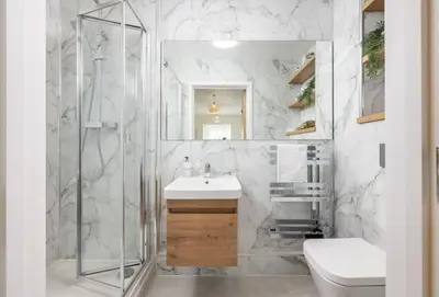 a white bathroom with a sink and a shower at 12 Ocean One in Newquay
