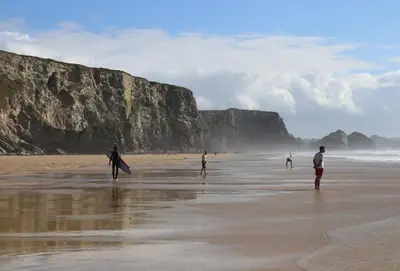 a group of people walking on the beach at 12 Ocean One in Newquay