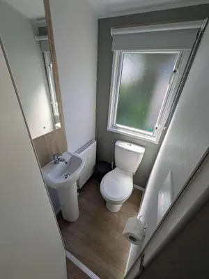 a small bathroom with a toilet and a sink at Willows Way Parkdean Newquay in Porth