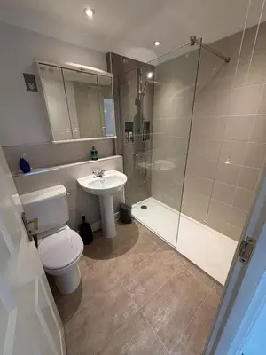 a bathroom with a toilet and a sink and a shower at Tamarin in Truro