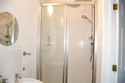 a bathroom with a shower and a sink at Sweetpea - Near Newquay - a tranquil hideaway in Saint Dennis