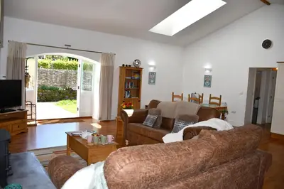 a living room with a couch and a tv at Sweetpea - Near Newquay - a tranquil hideaway in Saint Dennis