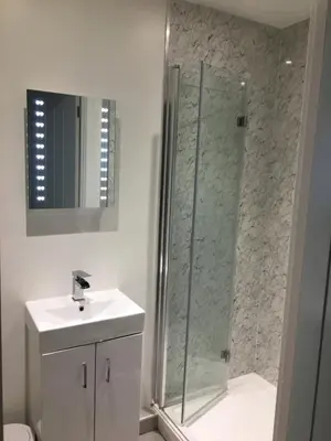 a bathroom with a shower and a sink at The Lodge in Truro