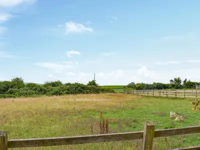 a pasture with a fence and a field of grass at Nutmeg's - Uk50373 in Camelford