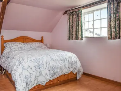a bedroom with a bed and a window at Nutmeg's - Uk50373 in Camelford