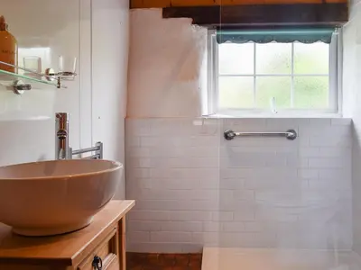 a bathroom with a bowl sink and a window at Skyber - Uk50374 in Camelford