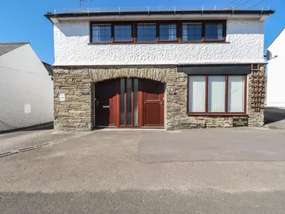 a building with a garage with a red door at The Loft in Truro