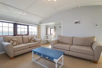a living room with two couches and a coffee table at The Loft in Truro
