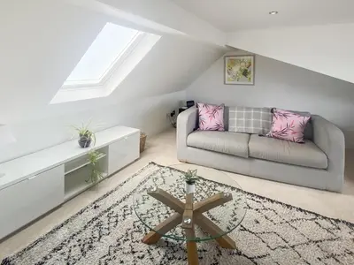 a living room with a couch and a table at The Loft - Uk50517 in Falmouth