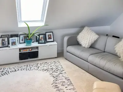 a living room with a couch and a window at The Loft - Uk50517 in Falmouth