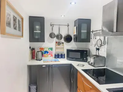a kitchen with a sink and a microwave at The Loft - Uk50517 in Falmouth