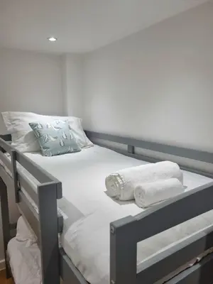 a bunk bed with towels on it in a room at Towan Valley, Porthtowan - Coastal 3 Bedroom Eco-Home with Hot Tub in Truro