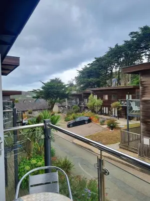 a balcony with a view of a parking lot at Towan Valley, Porthtowan - Coastal 3 Bedroom Eco-Home with Hot Tub in Truro