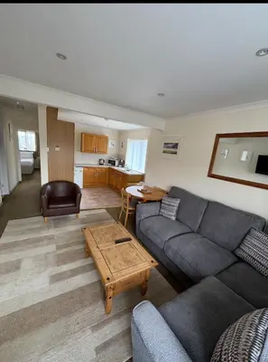 a living room with a couch and a table at Pirans Apartments in Perranporth