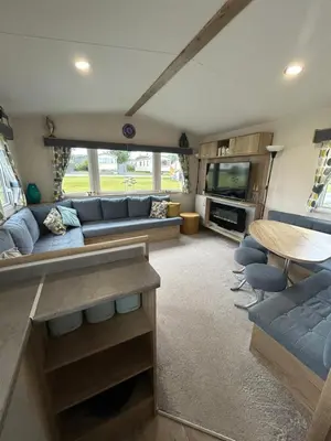 a living room with a couch and a table at L20 at Seven Bays Park in St Merryn