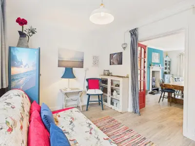 a living room with a couch and a table at Seaside 2-bed Home in Flushing with Free Parking & sea views in Falmouth