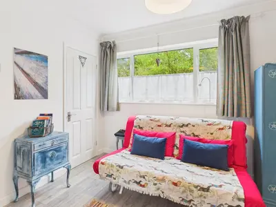 a living room with a couch and a window at Seaside 2-bed Home in Flushing with Free Parking & sea views in Falmouth