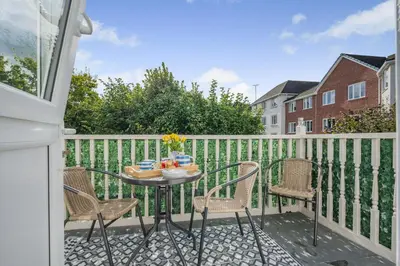 a patio with a table and chairs on a balcony at 2 Bed in Wadebridge oc-m32567 in Wadebridge