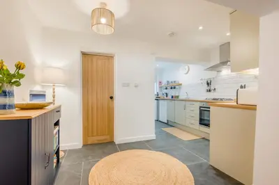 a kitchen with white cabinets and a rug on the floor at 2 Bed in Wadebridge oc-m32567 in Wadebridge