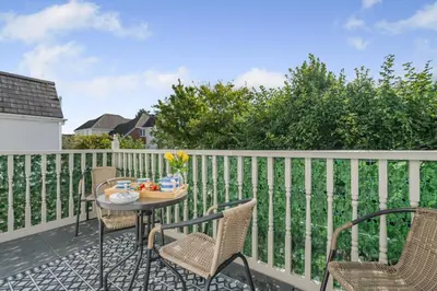 a patio with chairs and a table on a balcony at 2 Bed in Wadebridge oc-m32567 in Wadebridge