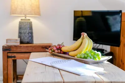 a bowl of bananas and grapes on a wooden table at 2 Bed in St. Martin oc-b33429 in Saint Martin