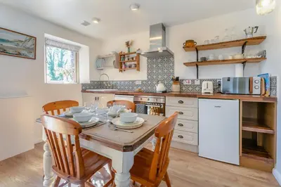 a kitchen with a wooden table and chairs and a kitchen with a counter at 2 Bed in St. Martin oc-b33429 in Saint Martin